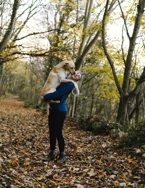 woman carrying dog